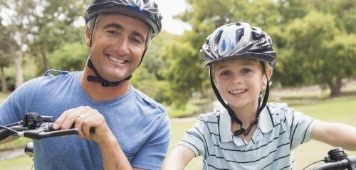 boy and father biking web