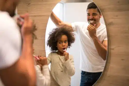 dad daughter brushing teeth