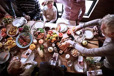 family around thanksgiving spread