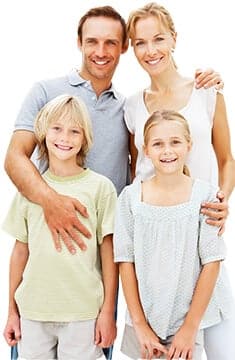 family smiling outdoors hugging