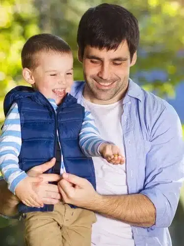 father and son spending time together in sunny nature