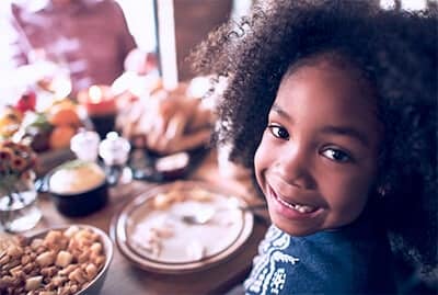 girl smiling at dinner table