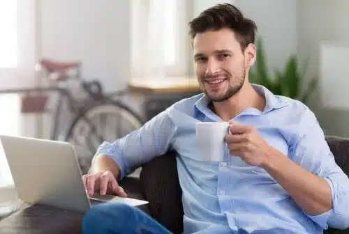 man drinking from mug