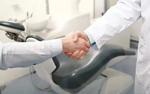 shaking hands dentist office