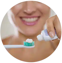 woman applying thoothpaste to brush