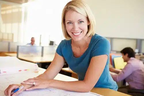 woman smiling at drafting table web