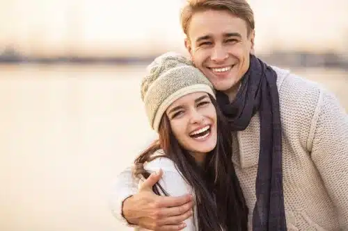 young couple smiling on beach